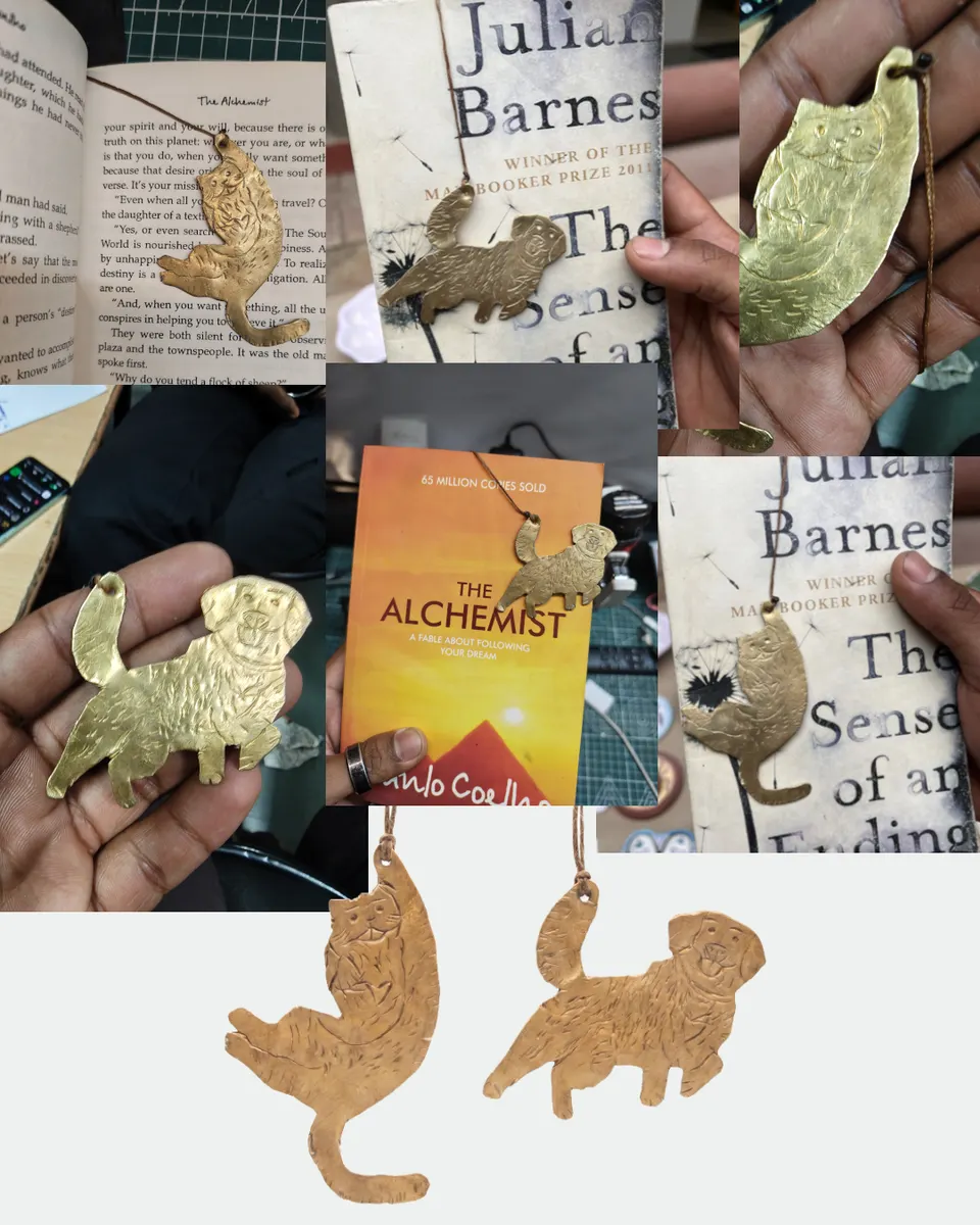 The cat and dog bookmarks marking pages in The Alchemist and The Sense of an Ending, one inside and one hanging out