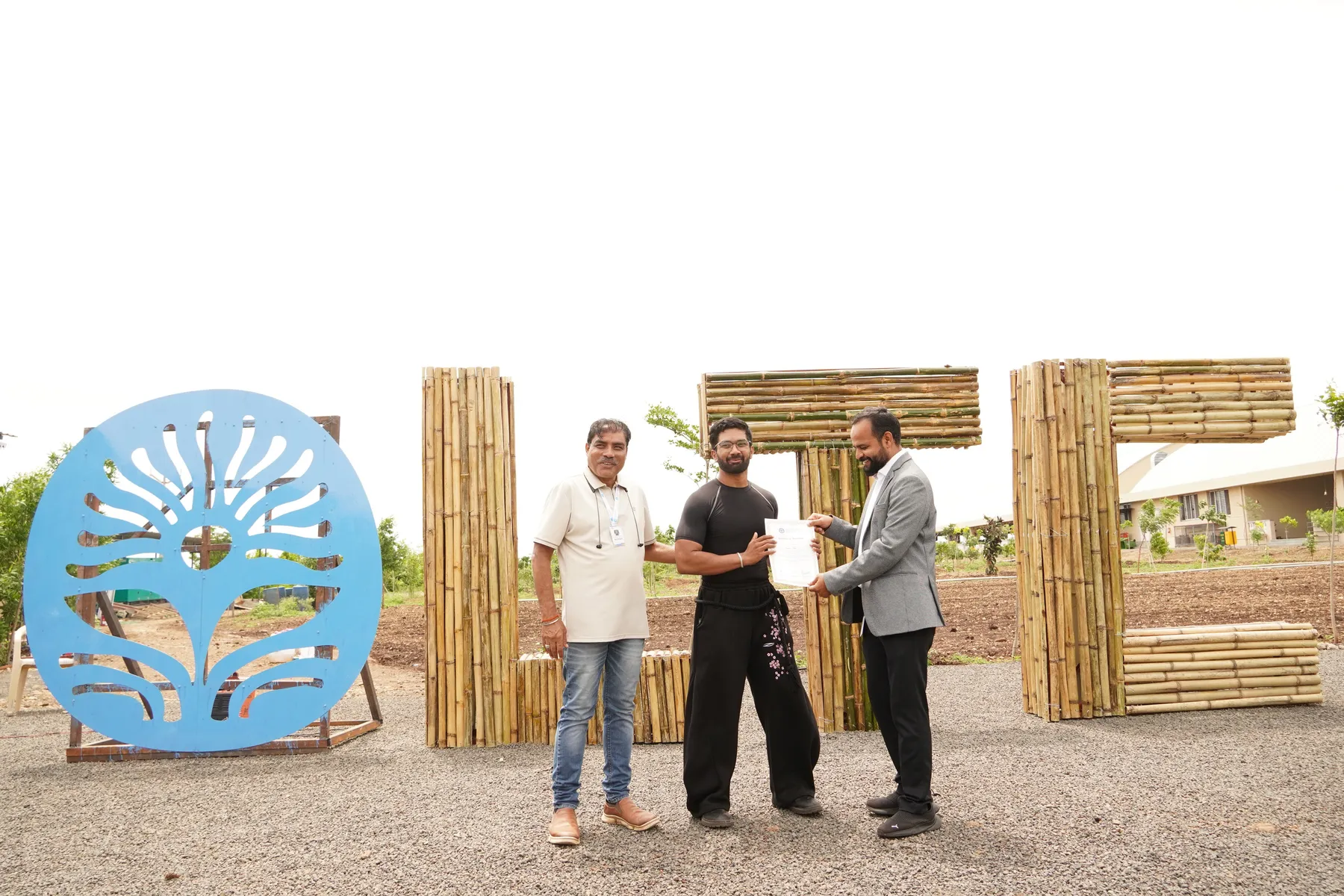 The bamboo LTC letters and the blue laser-cut emblem at the campus entrance, with Pranshu receiving his internship certificate