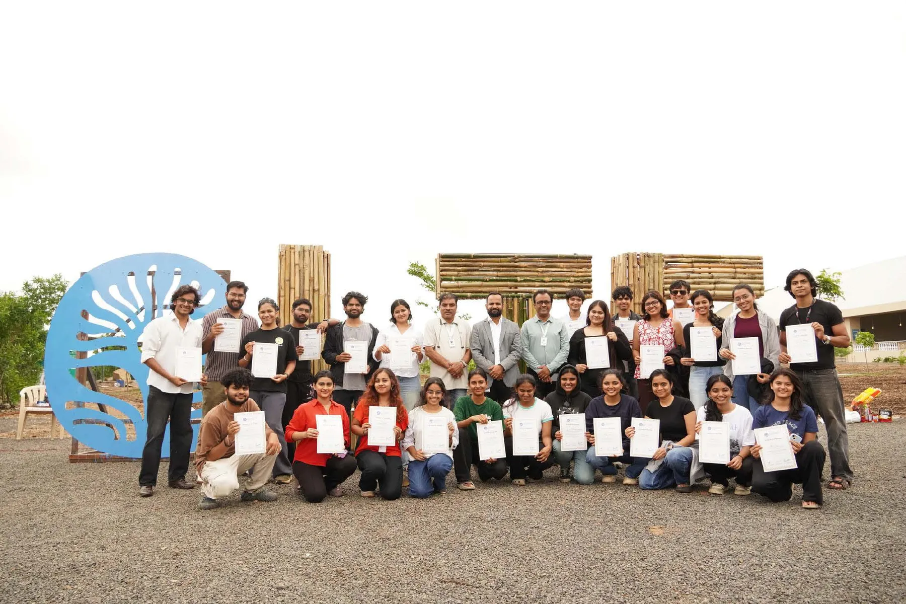 The 25 interns with their certificates in front of the finished LTC letters